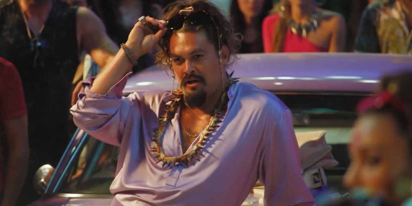 Dante (Jason Momoa) provocatively leaning on his car before as street race in Fast X