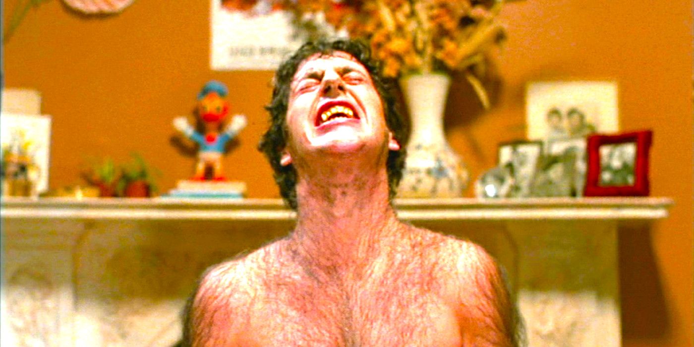 David Naughton grimaces with pain while werewolf hairs sprout on his body in An American Werewolf in London