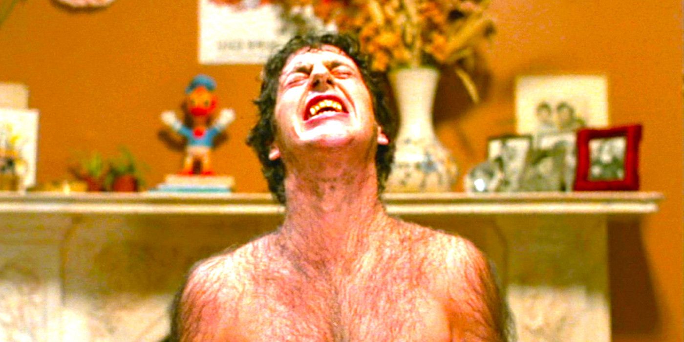 David Naughton grimacing while sprouting hairs during a werewolf transformation in An American Werewolf in London
