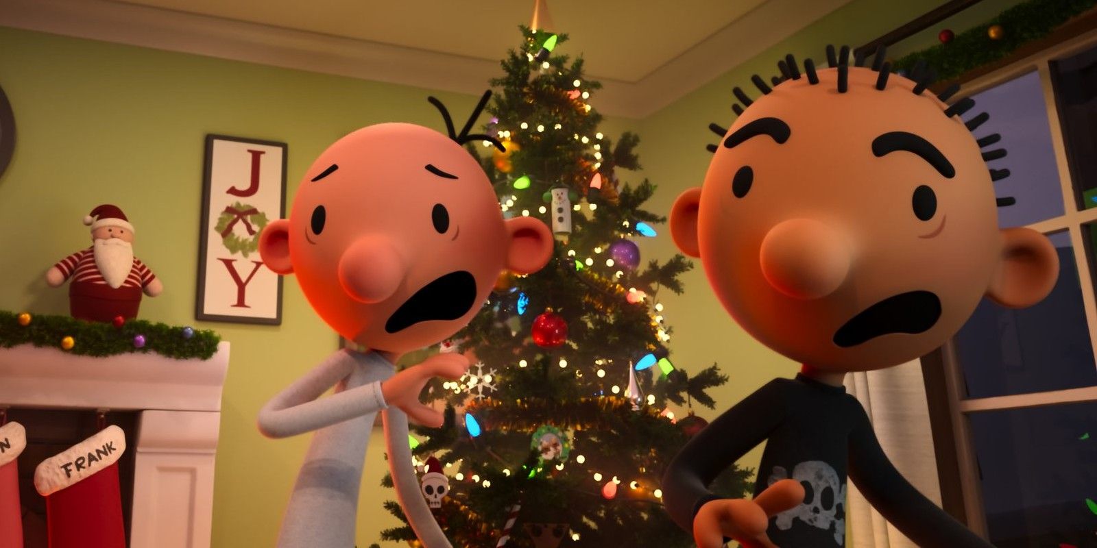 Greg in front of a Christmas tree in Diary of a Wimpy Kid Christmas: Cabin Fever