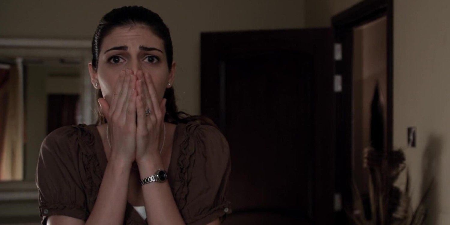 A character with her hands to her face in the 2013 Tobe Hooper movie Djinn 