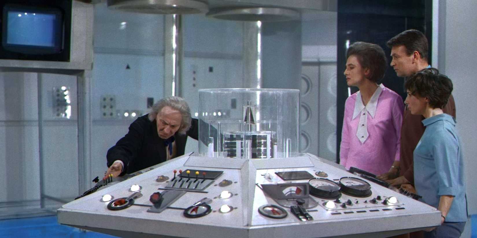 William Hartnell as the First Doctor at the TARDIS console in Doctor Who as his companions watch on.