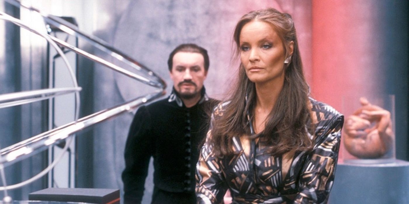 Doctor Who's Kata O'Mara as the Rani, Anthony Ainley as the Master stood in a lab