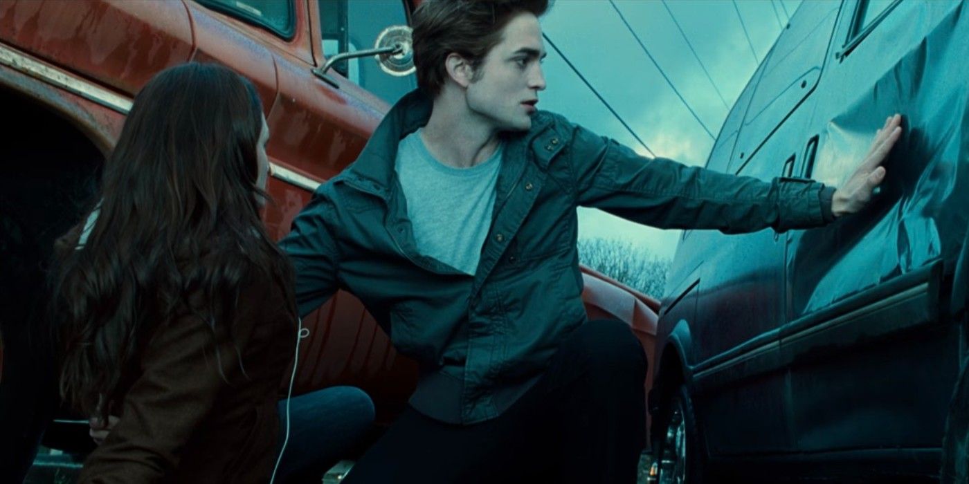 Edward (Robert Pattinson) stops a car with his hand and protects Bella (Kristen Stewart) in Twilight