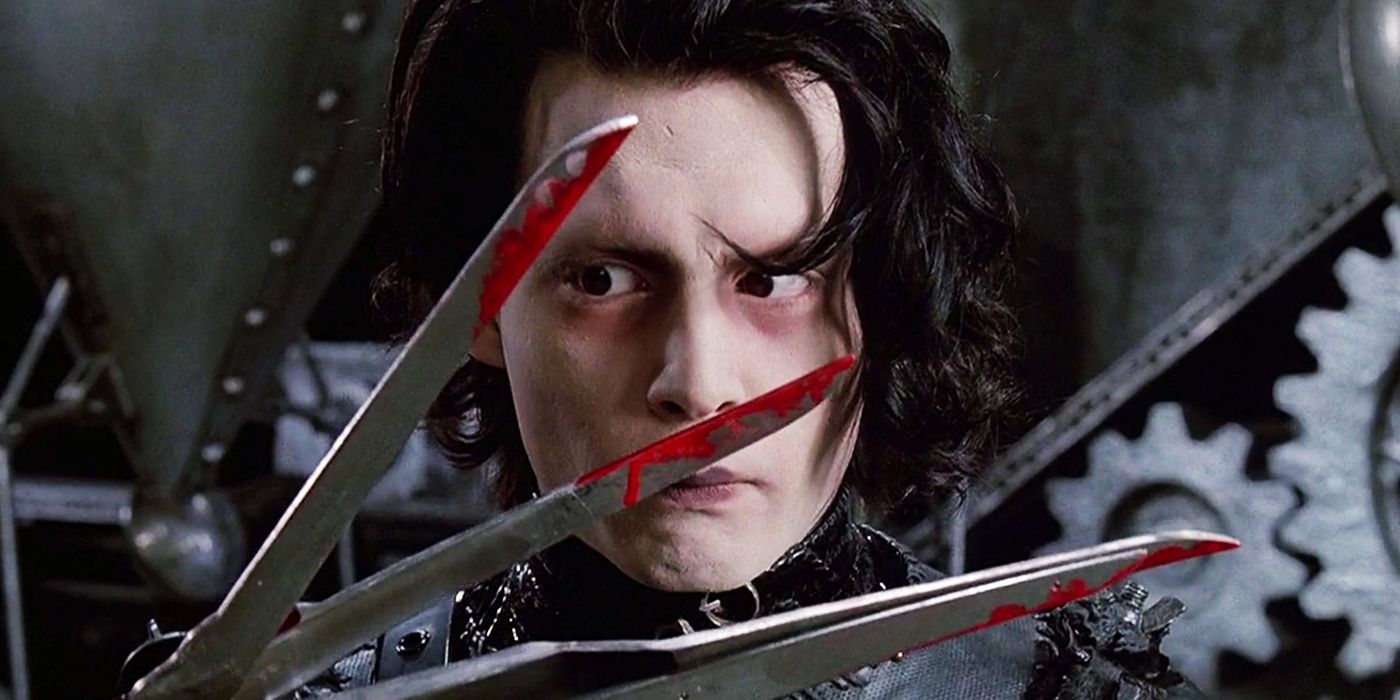 Edward Scissorhands wears a worried facial expression as he examines the blood that's on his scissor hands in Edward Scissorhands