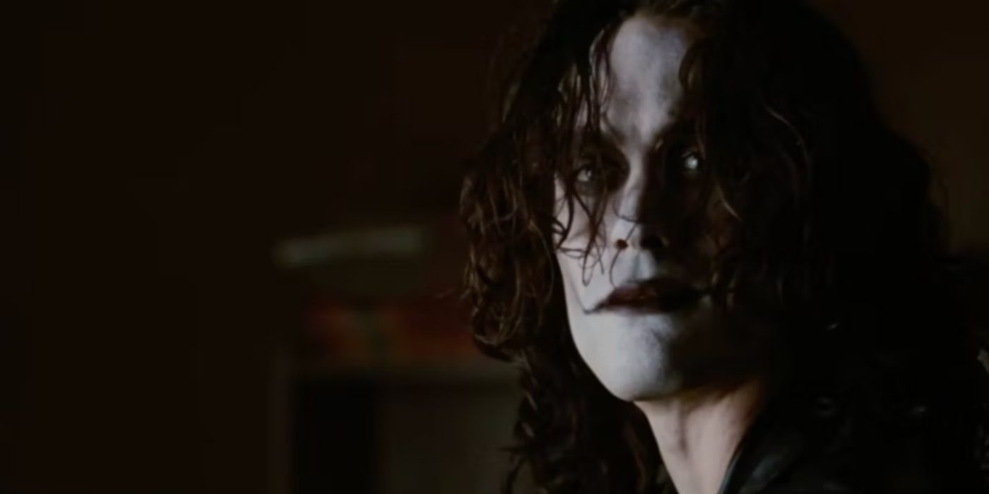 Eric Draven looking on from the shadows in The Crow.