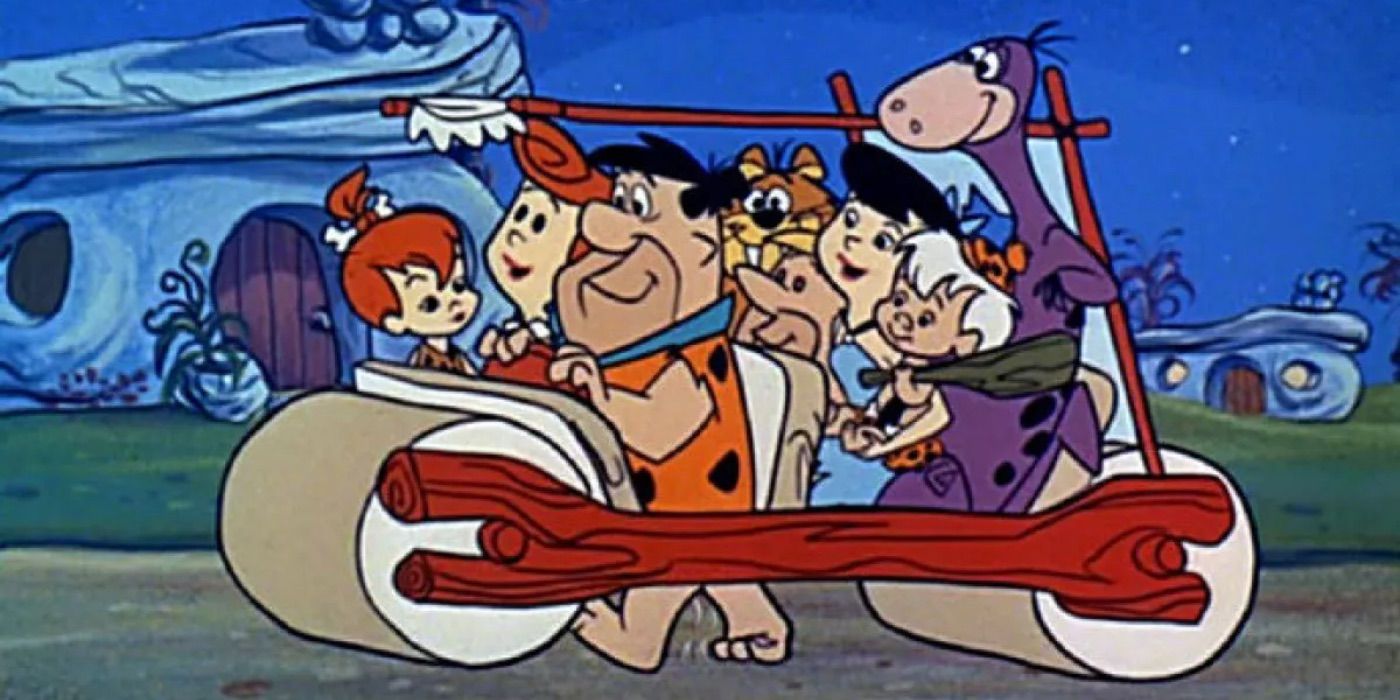 The Flintstone family in their car.