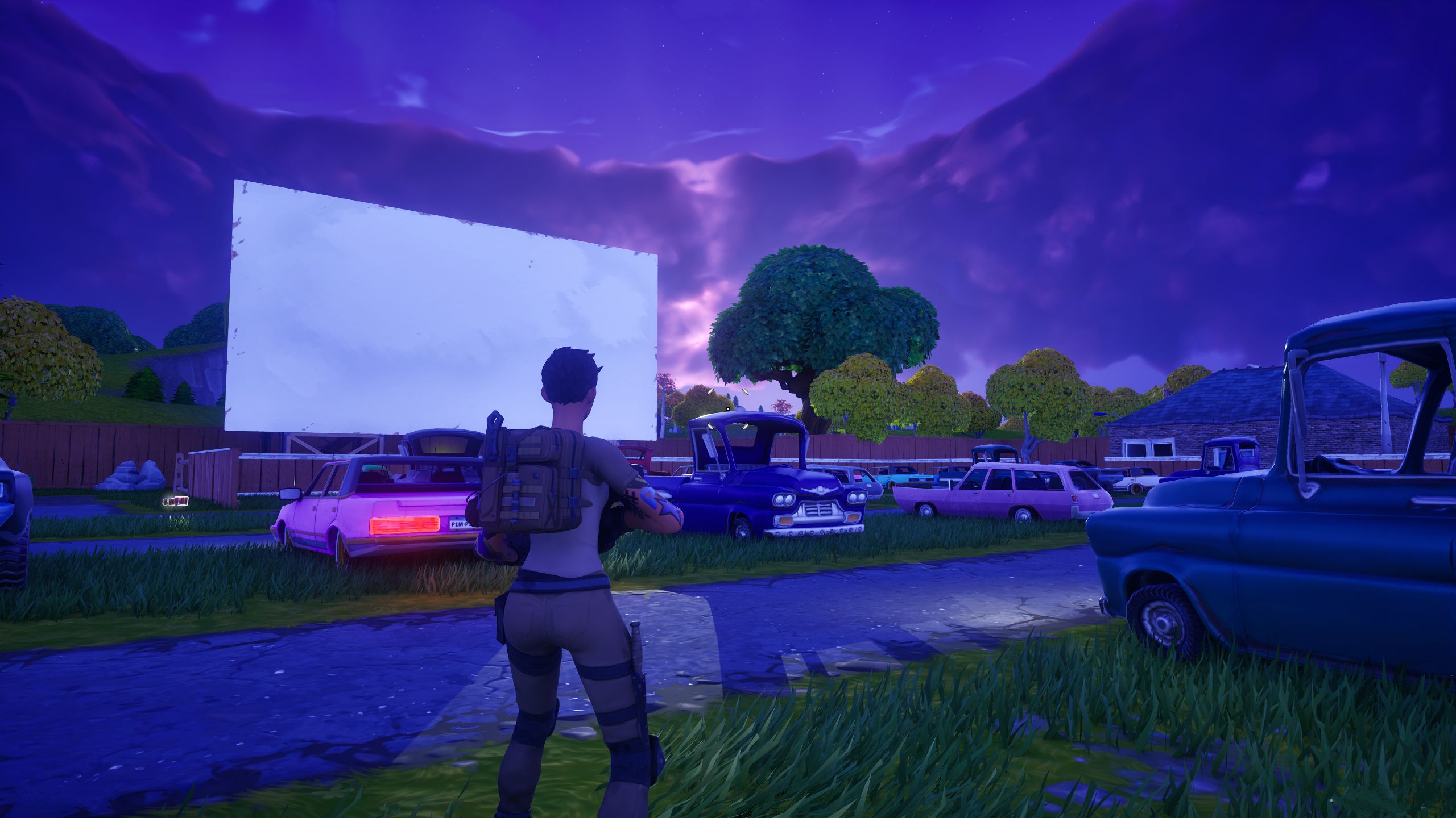 Fortnite Chapter 4 Season OG Player Character Facing Movie Screen And Cars At Risky Reels