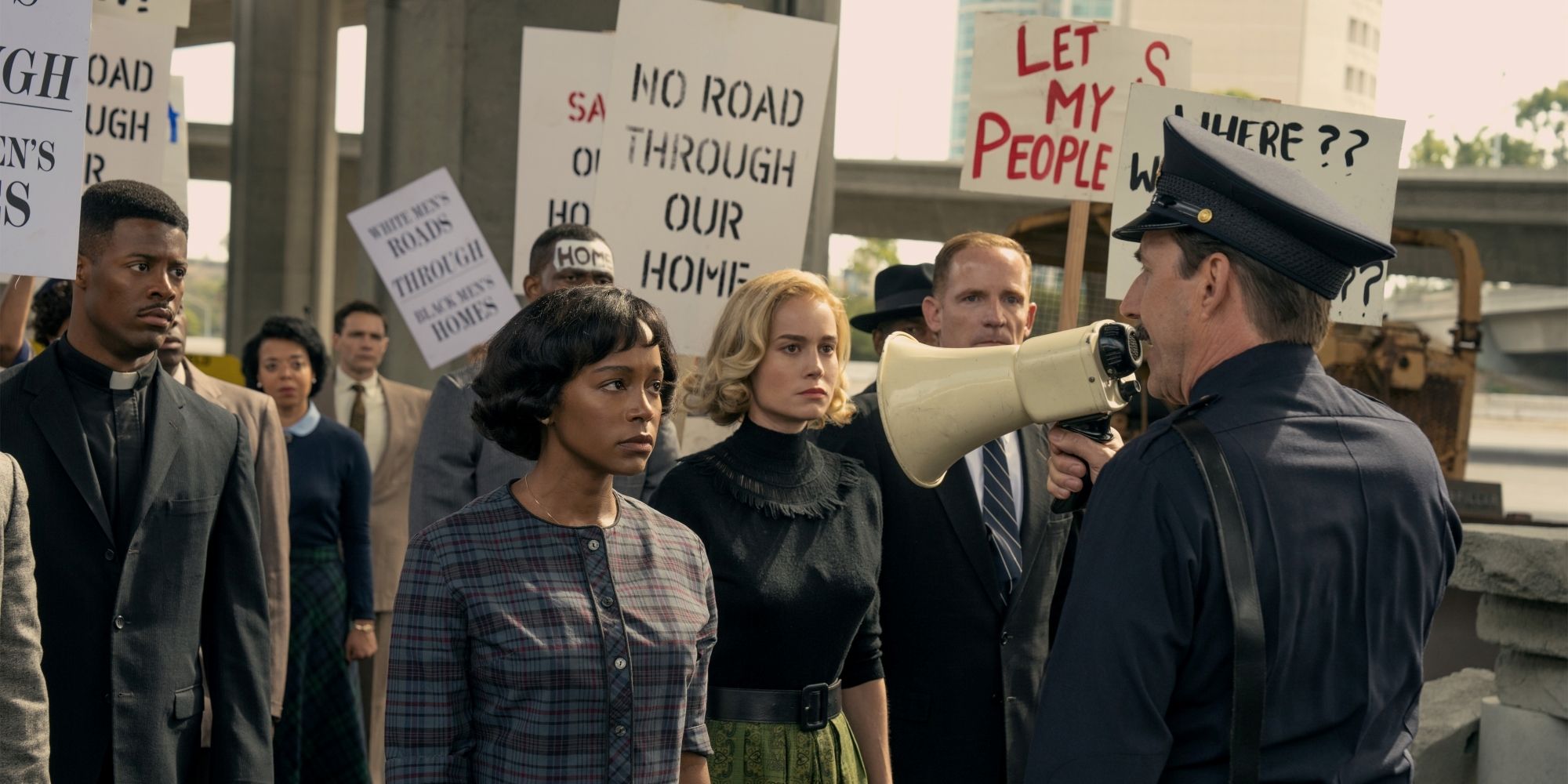 Reverend Wakely, Harriet & Elizabeth Face Police At Freeway Protest In Lessons In Chemistry Episode 6.jpg
