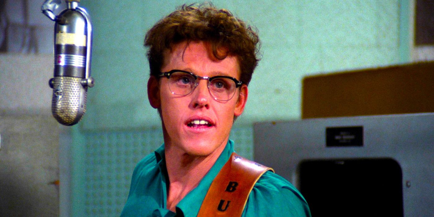 Gary Busey talks from behind a microphone as Buddy Holly in The Buddy Holly Story