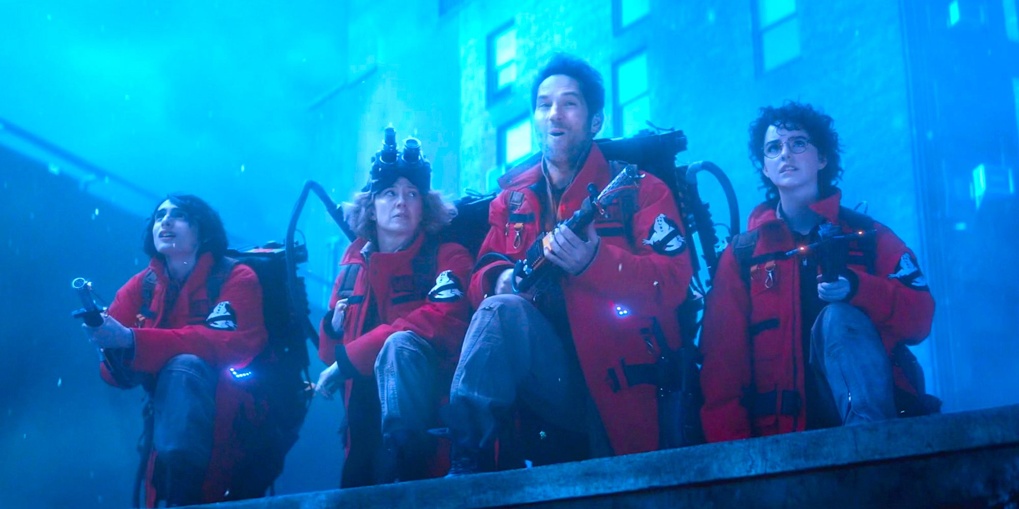 The new team lined up in red suits on a rooftop in the Ghostbusters Frozen Empire trailer