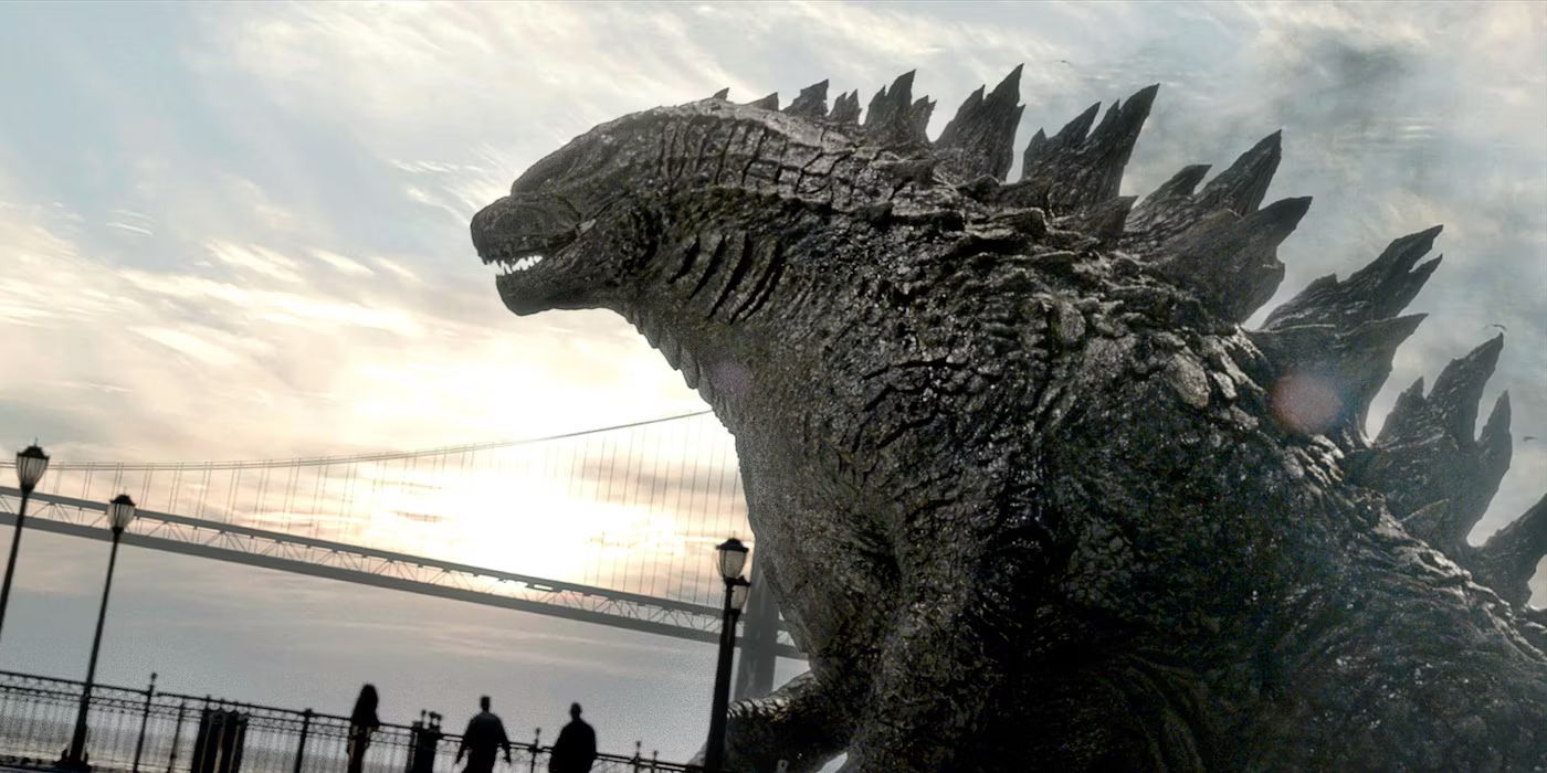 Godzilla walks in front of a bridge with the sun past the horizon in Godzilla (2014)
