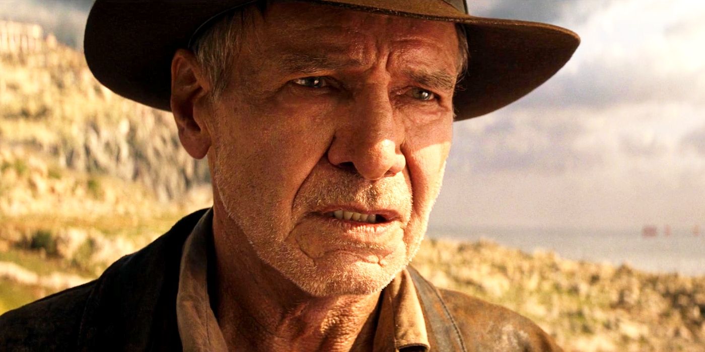 Harrison Ford looking weathered and weary as Indiana Jones with the ocean in the background.
