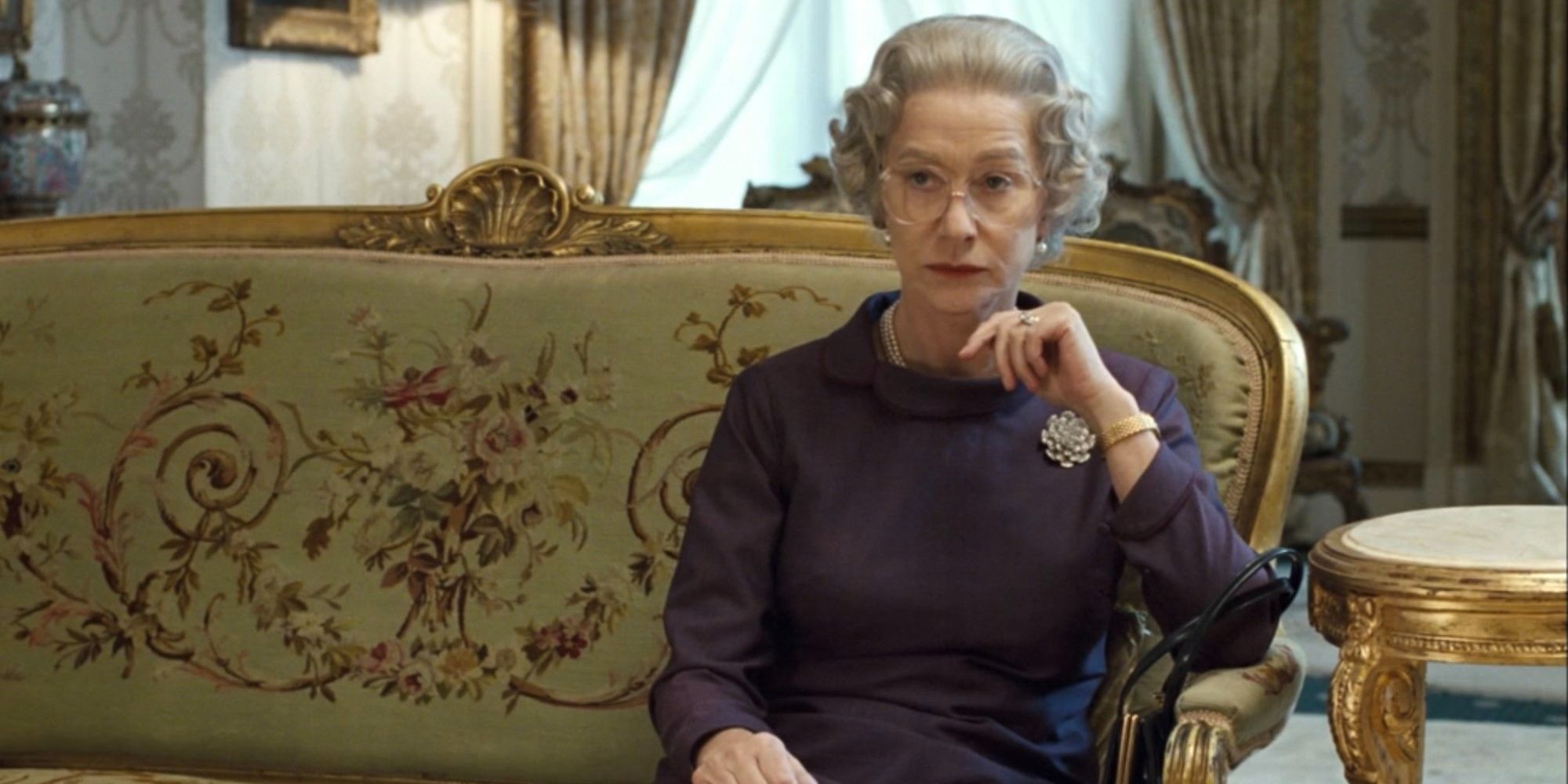 helen mirren looking serious in a palace in the queen
