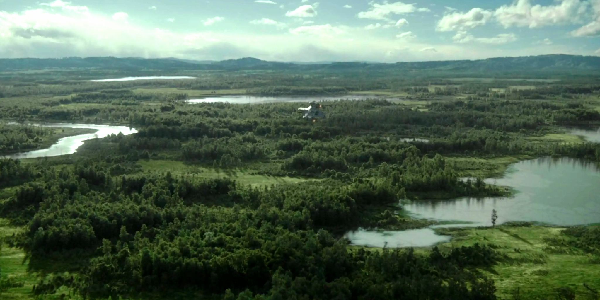 The Razor Crest soars above the planet of Sorgan and its trees and ponds in The Mandalorian season 1, episode 4