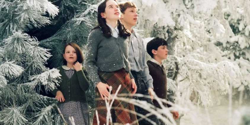 Georgie Henley Anna Popplewell William Moseley and Skandar Keynes as Lucy Susan Peter and Edmund walk out of the trees in The Chronicles of Narnia. 