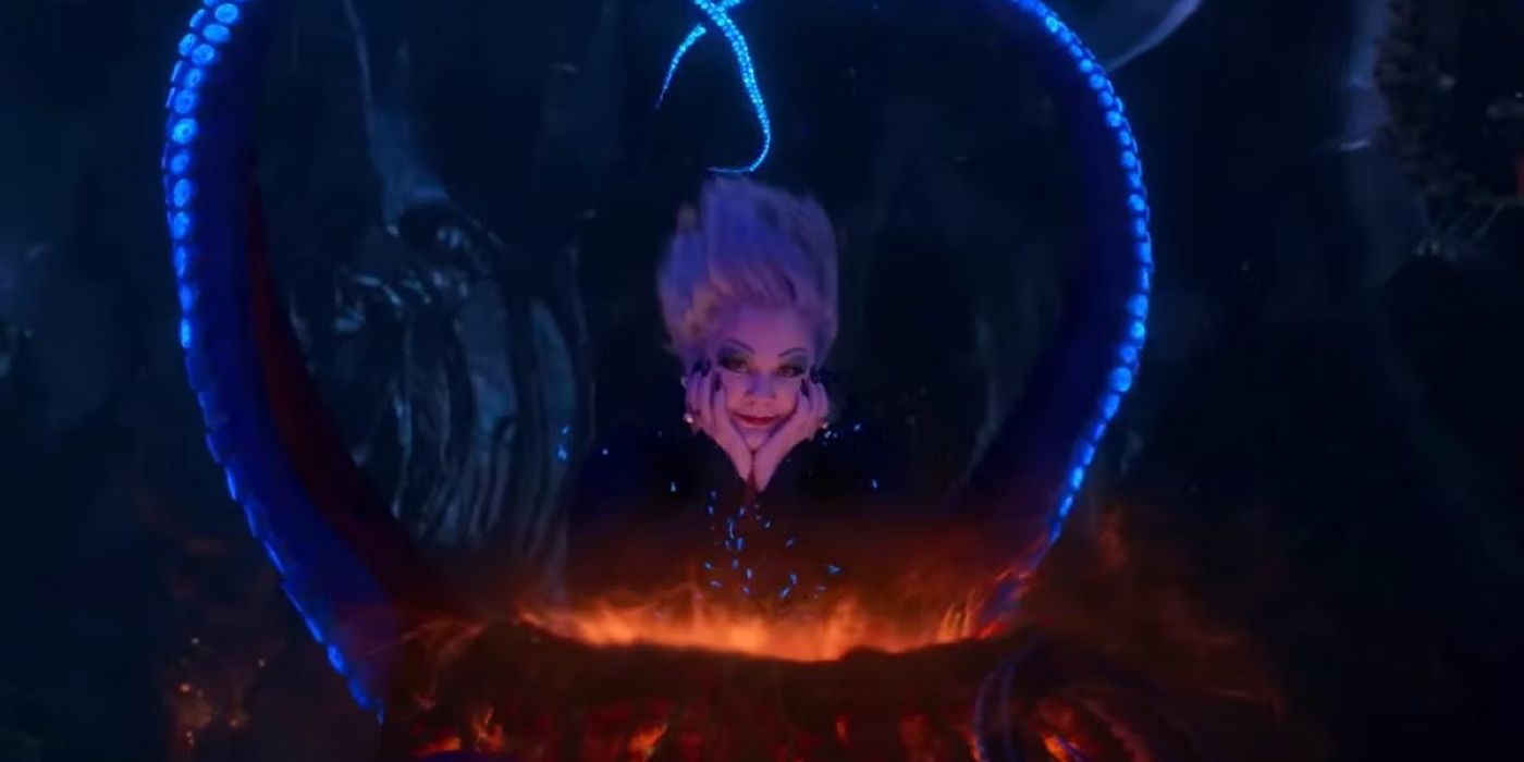 Melissa McCarthy Ursula with her hands under her chin and her tentacles making a heart in The Little Mermaid 2023. 