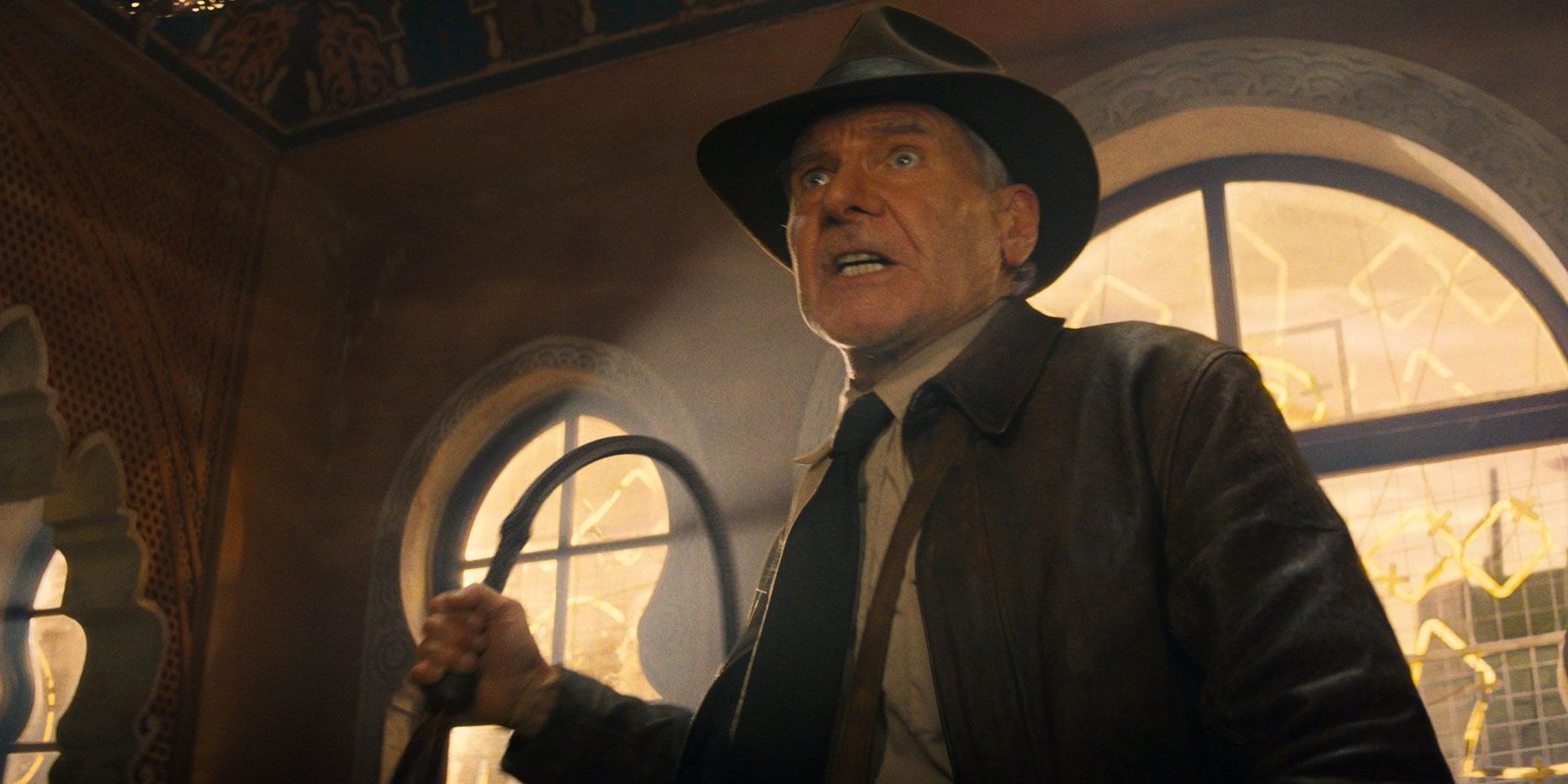Indy (Harrison Ford) holding his whip in Indiana Jones and the Dial of Destiny