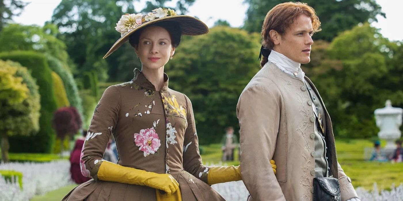 Claire holding Jamie's arm, both dressed formally, in Outlander