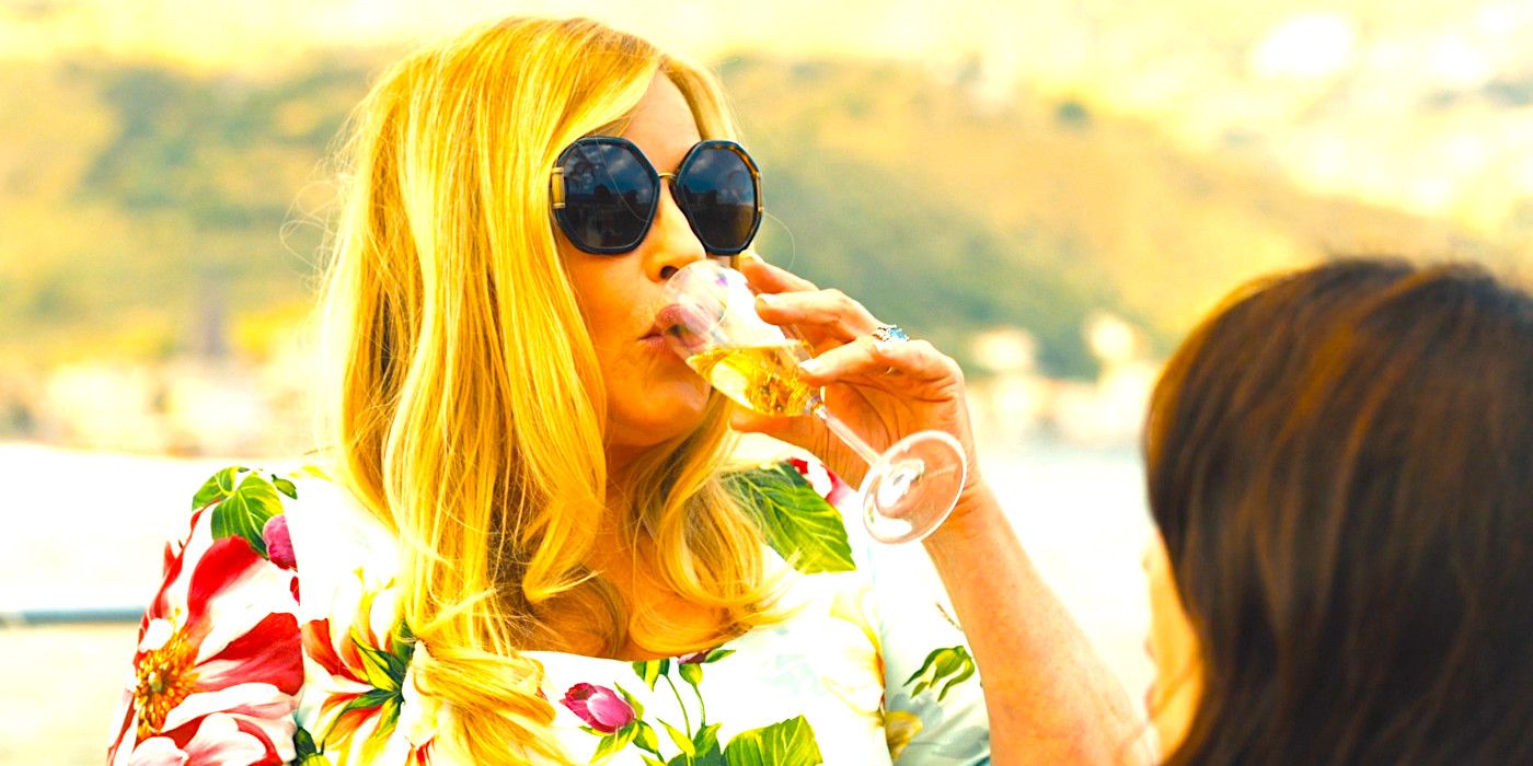 Jennifer Coolidge as Tanya sips champagne in the sun in The White Lotus season 2