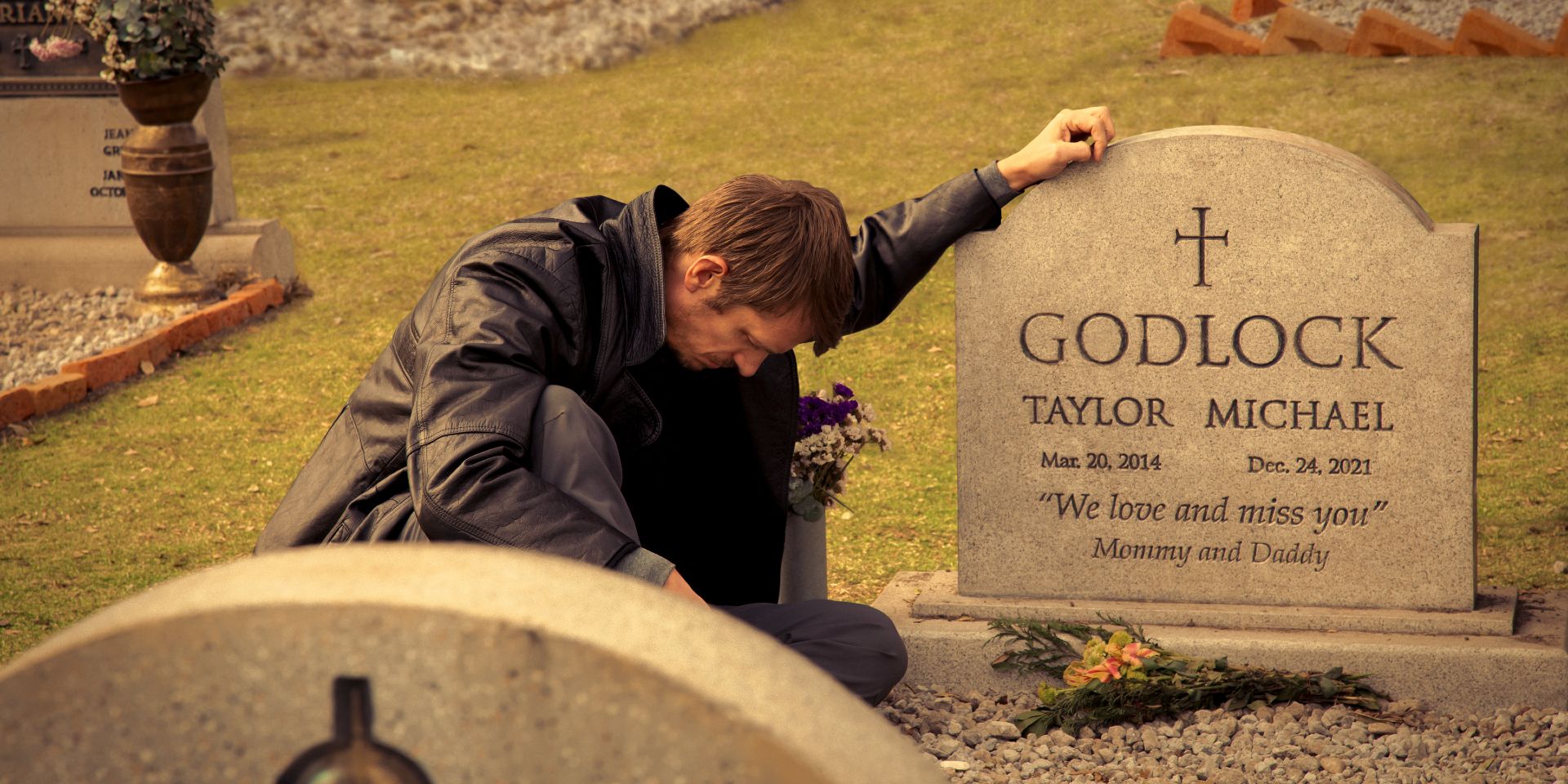 Joel Kinnaman at a gravestone in Silent Night