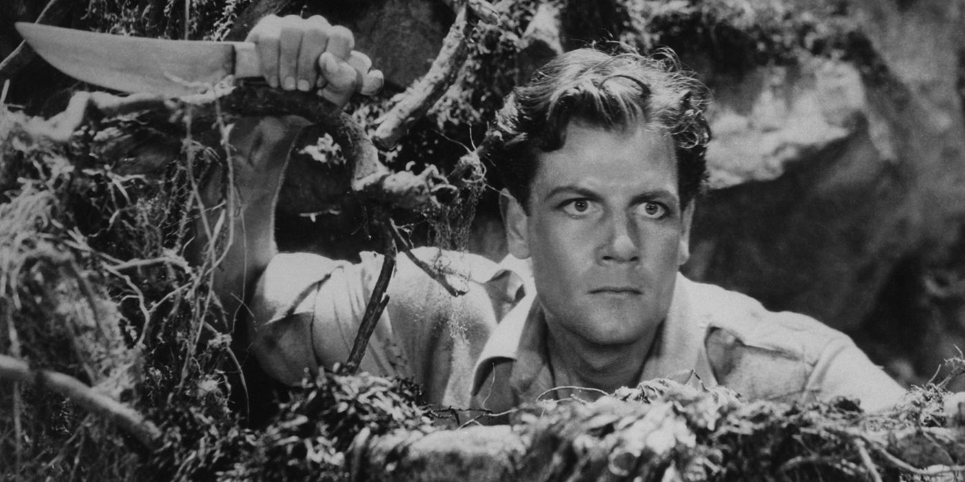 Joel McCrea holding a knife in the woods in The Most Dangerous Game (1932). 