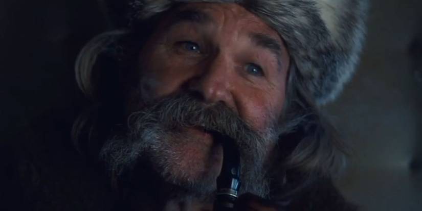 Kurt Russell as John Ruth conversing with Major Marquis Warren inside OB's stagecoach in 2015's The Hateful Eight
