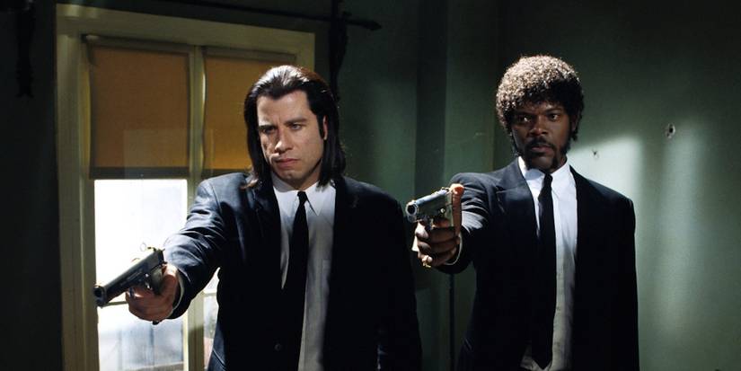 John Travolta as Vincent and Samuel L. Jackson as Jules pointing guns in Pulp Fiction
