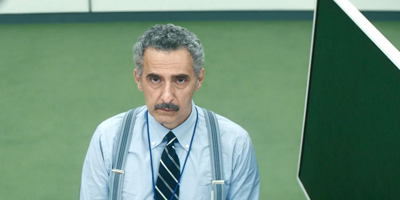 John Tuturro looking up from his cubicle in Severance
