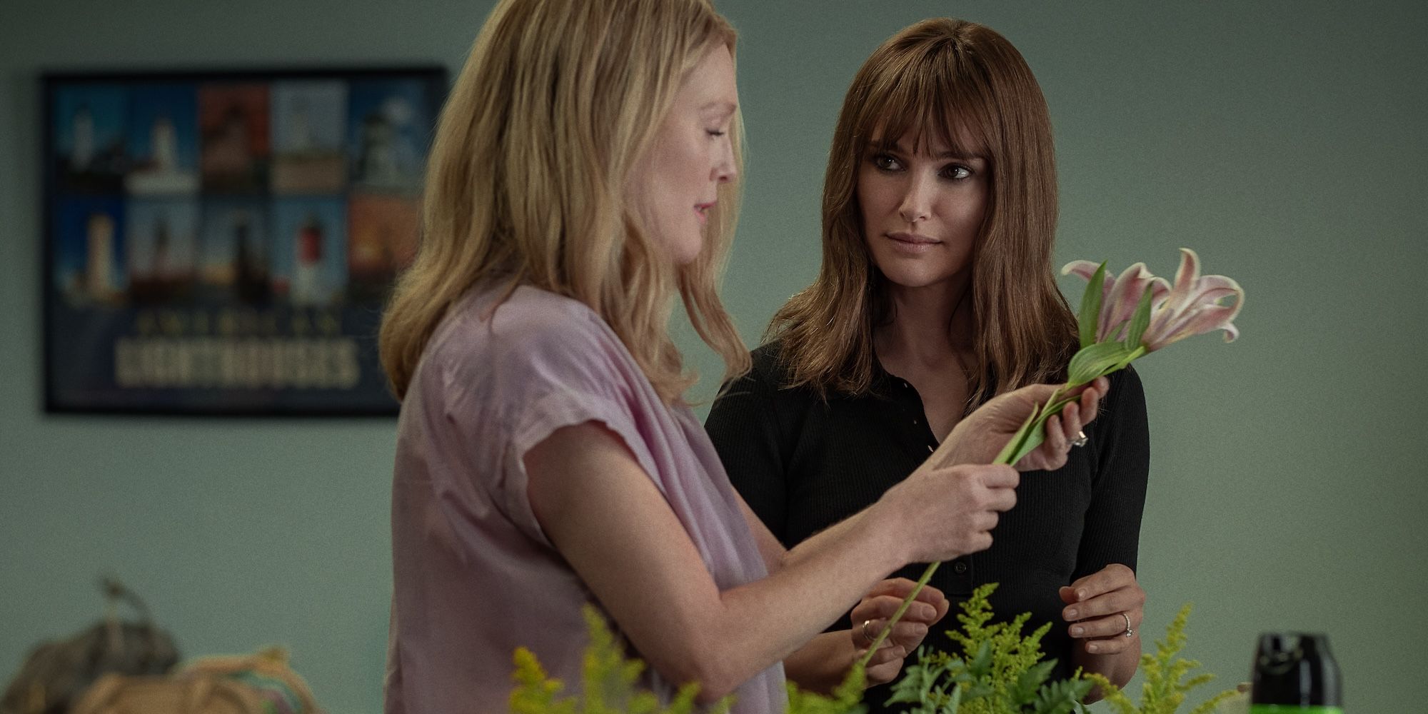Julianne Moore and Natalie Portman look at flowers in May December