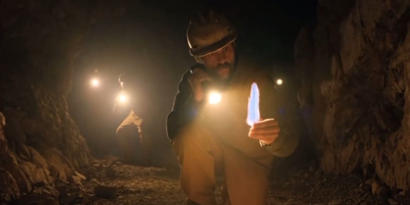 Julio Cesar Cedillo as Dr. Juan Carlos Ortega holding up a feather in a cave in Chupa.