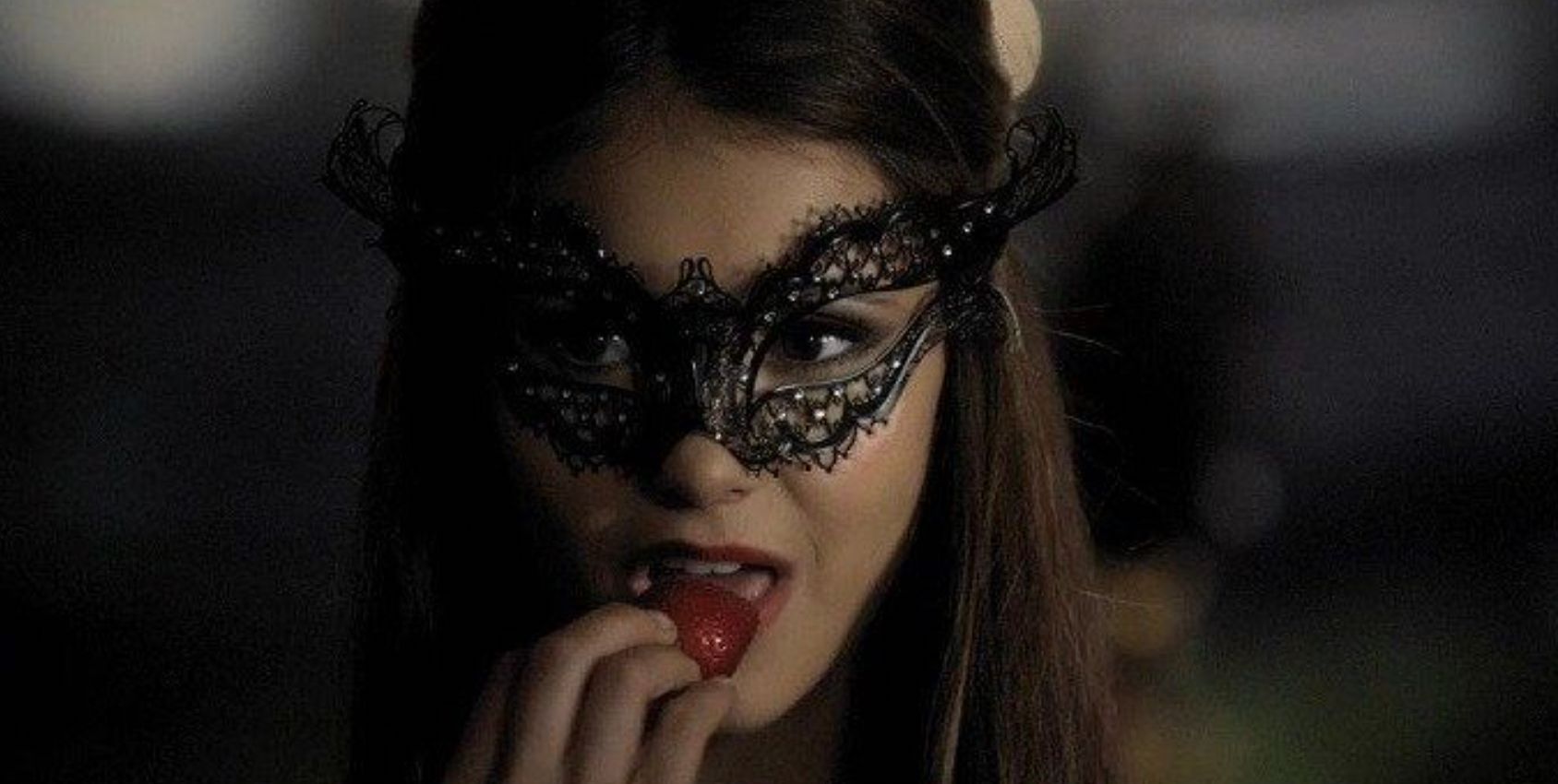 Katherine eating a strawberry in The Vampire Diaries Masquerade episode