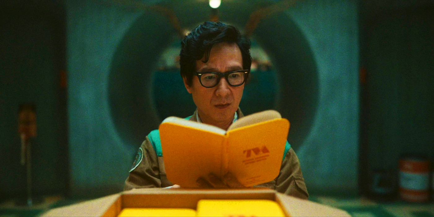 Ke Huy Quan's Ouroboros reading the new TVA guidebook in Loki season 2's finale
