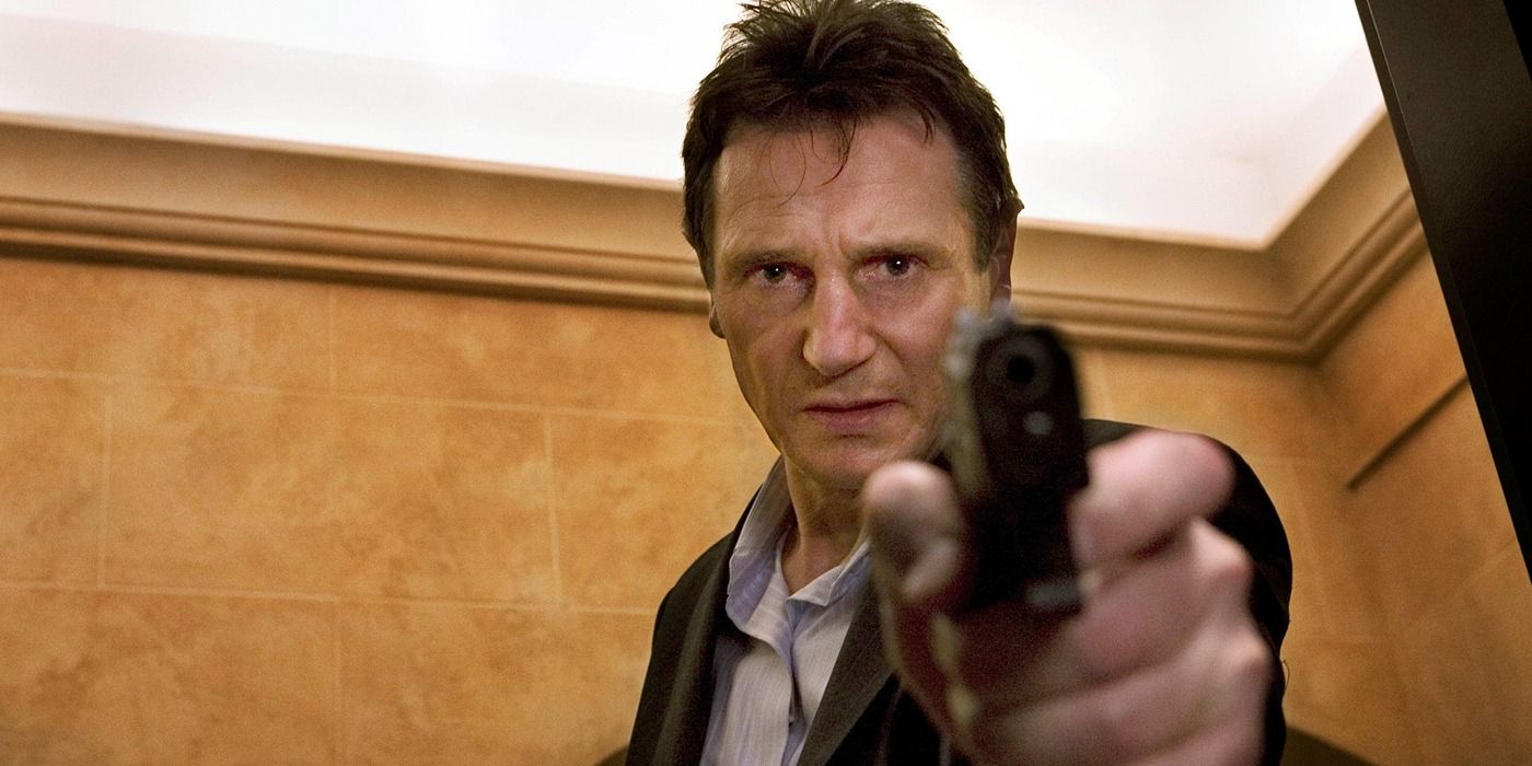 Liam Neeson pointing a gun at the camera in Taken 