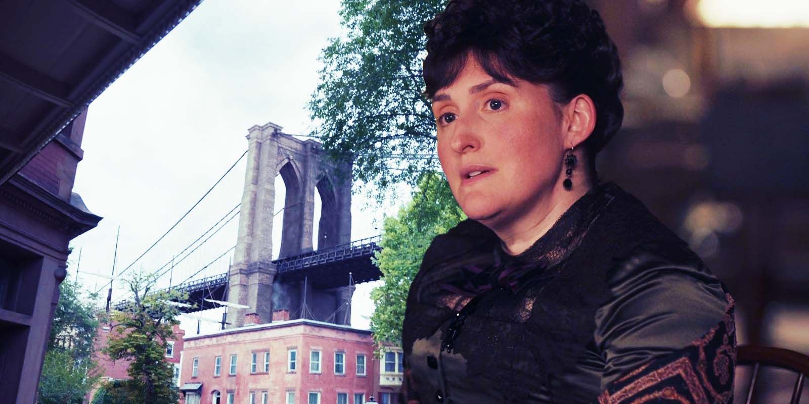 Liz Wisan as Emily Warren Roebling with a background of the Brooklyn Bridge in The Gilded Age season 2