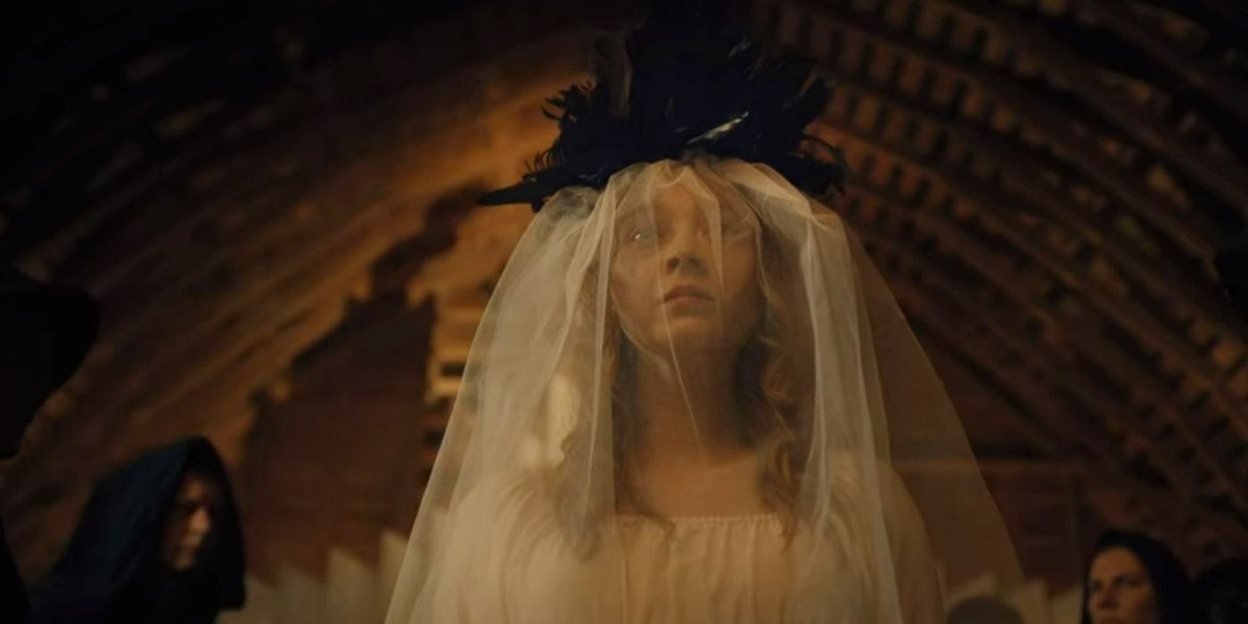 Mae wearing a wedding dress and a black feather crown in Devil in Ohio.