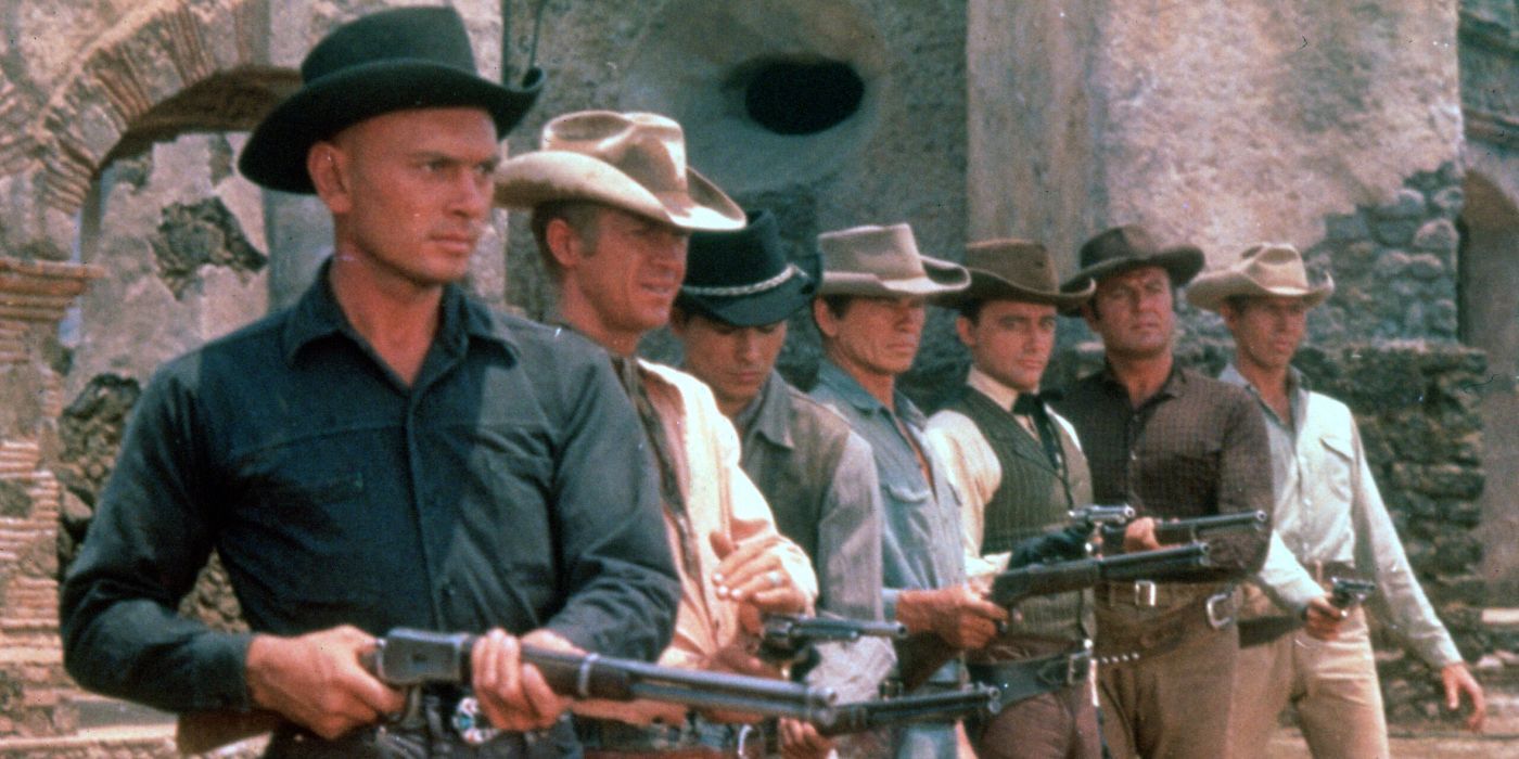 The Magnificent Seven standing in a line with guns pointed