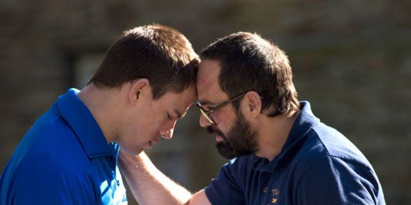 Mark Ruffalo leaning his head against Channing Tatum's in Foxcatcher