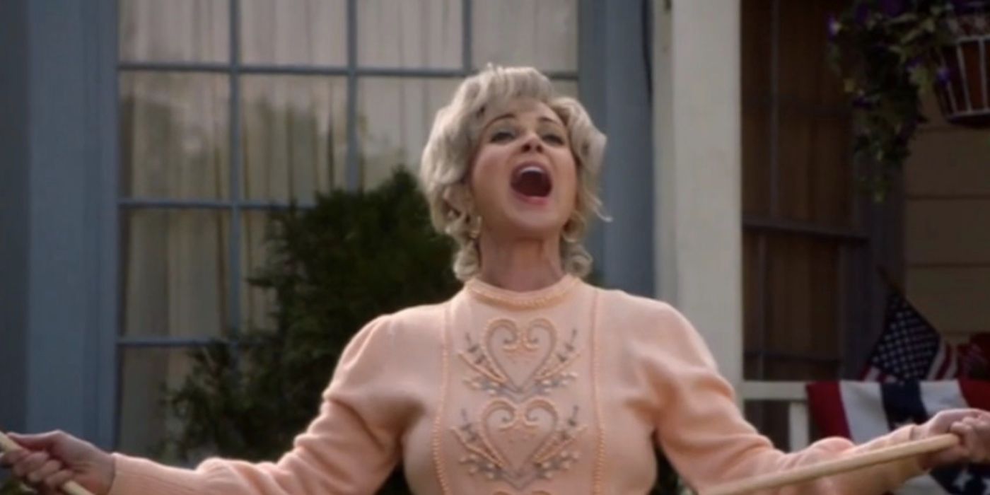 Annie Potts as Meemaw waves a flag in Young Sheldon season 2 episode 16