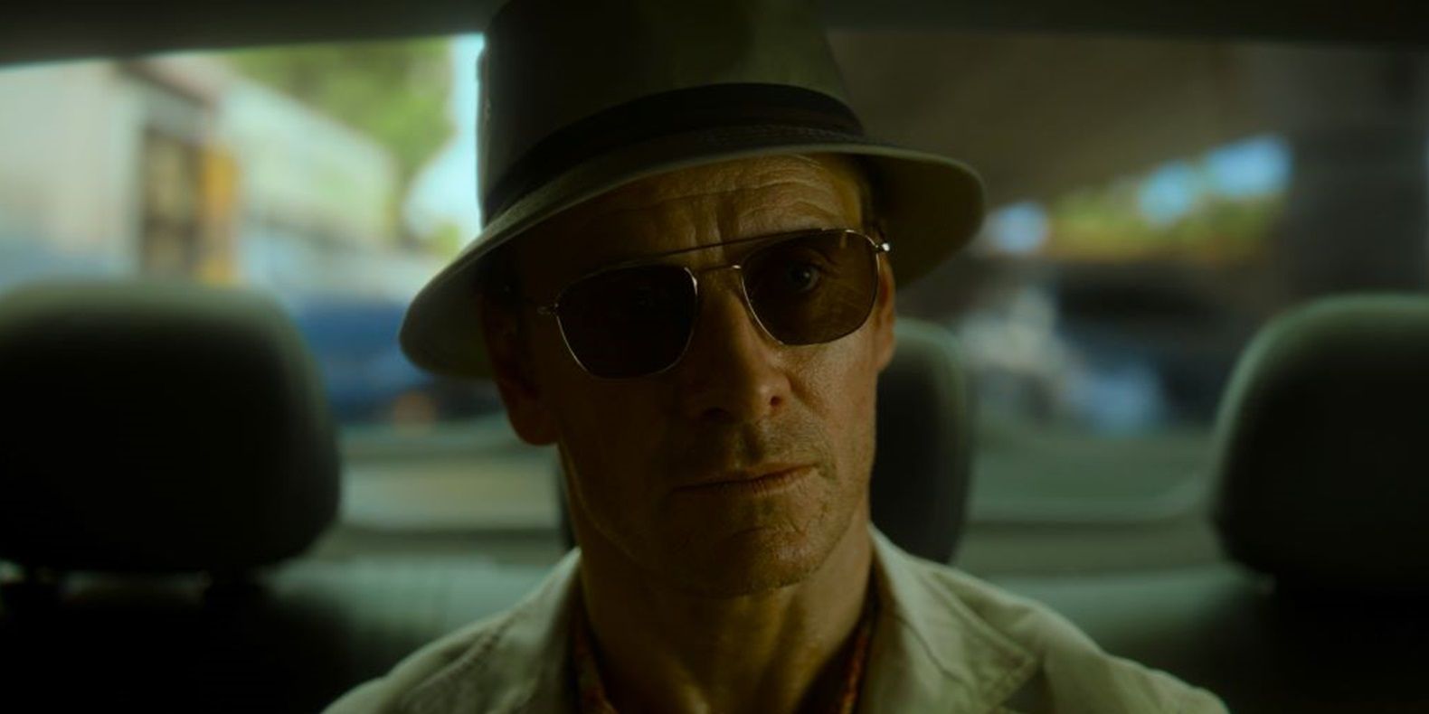 Michael Fassbender sits in a taxi in The Killer