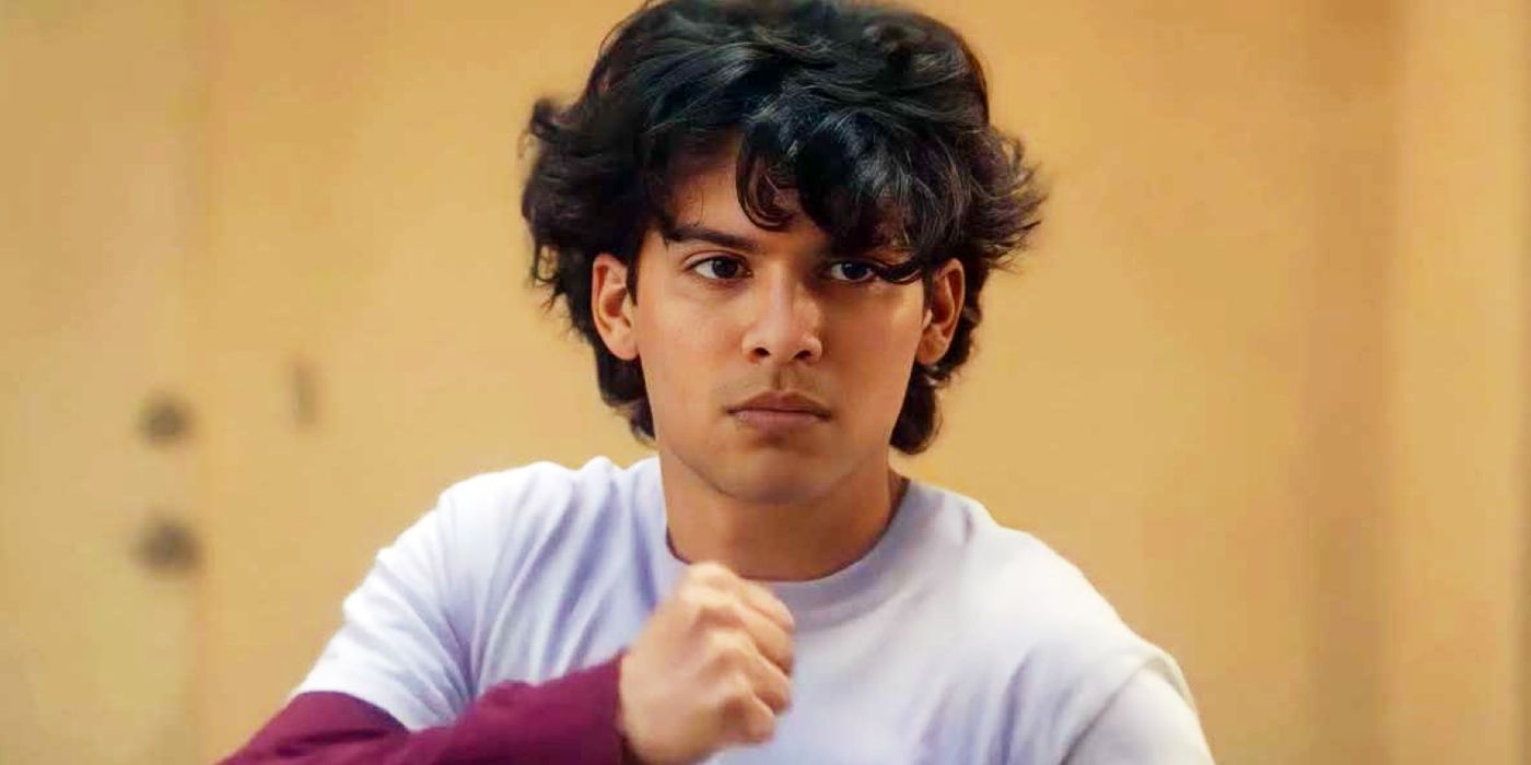 Xolo Maridueña with his fist raised as Miguel Diaz in Cobra Kai.