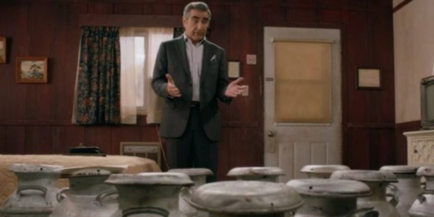 Johnny surrounded by milk jugs in Schitt&rsquo;s Creek.
