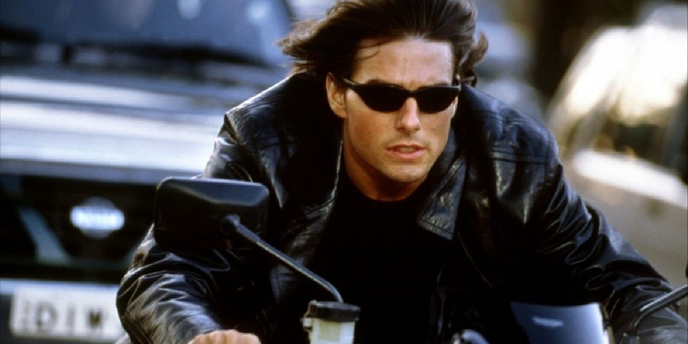 Tom cruise as Ethan Hunt riding motorcycle and wearing sunglasses in Mission: Impossible 2.