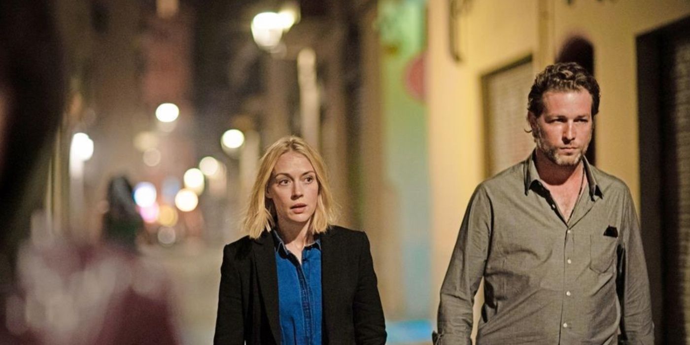 Miranda Blake (Elen Rhys) and Max Winter (Julian Looman) walk along a dark street in The Mallorca Files
