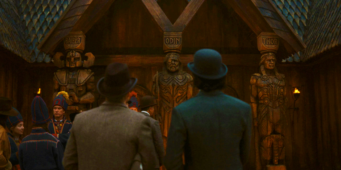 Mobius and Loki in Chicago looking at Balder, Odin, and Thor statues