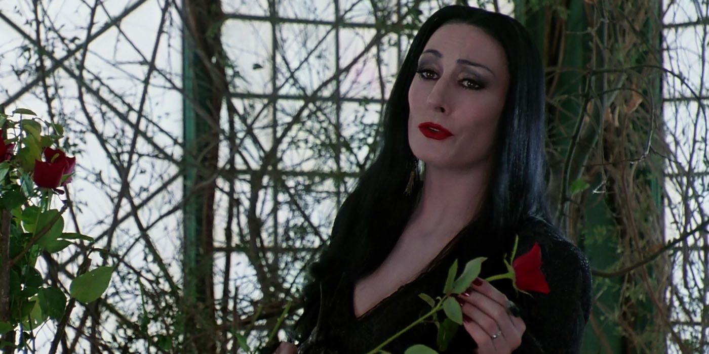 Morticia Addams holding a rose in The Addams Family