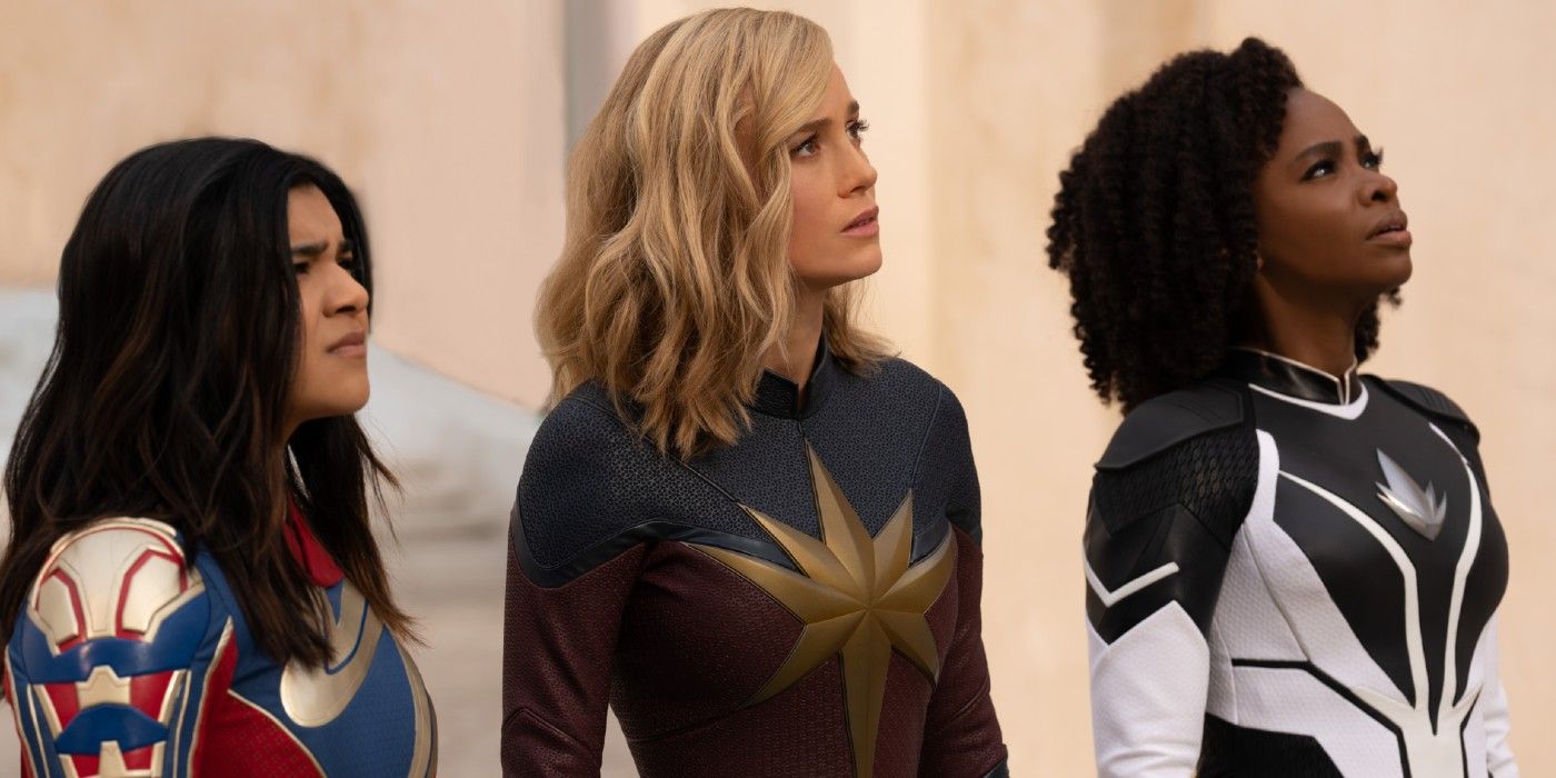 Ms. Marvel (Iman Vellani), Captain Marvel (Brie Larson) , and Monica Rambeau (Teyonah Parris) stand together and stare an an unknown threat in The Marvels