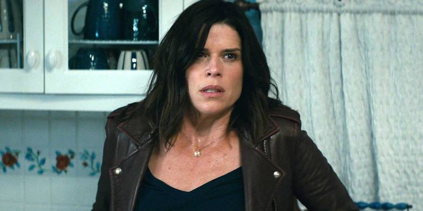 Neve Campbell as Sidney Prescott wearing a brown jacket in Scream 2022