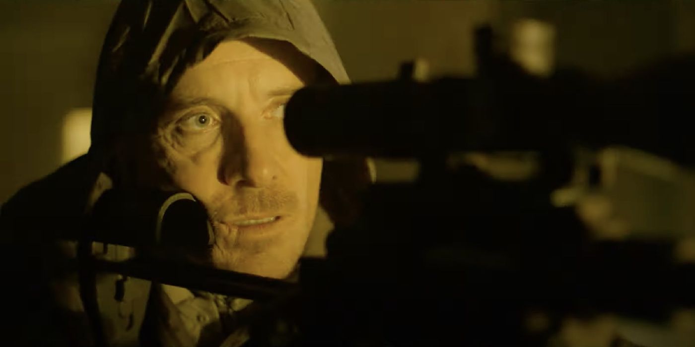 Michael Fassbender looking through the scope of a sniper rifle in The Killer
