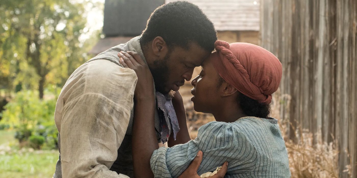 Zackary Momoh as John Tubman and Cynthia Erivo as Harriet Tubman embracing in Harriet